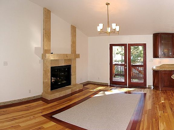 Dining area with fireplace and deck access