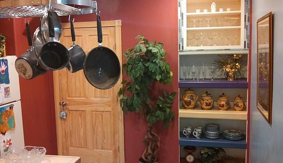 Uplifting colors with the built in shelving unit. Stainless Steel hanging pot rack for the enterprising cook!