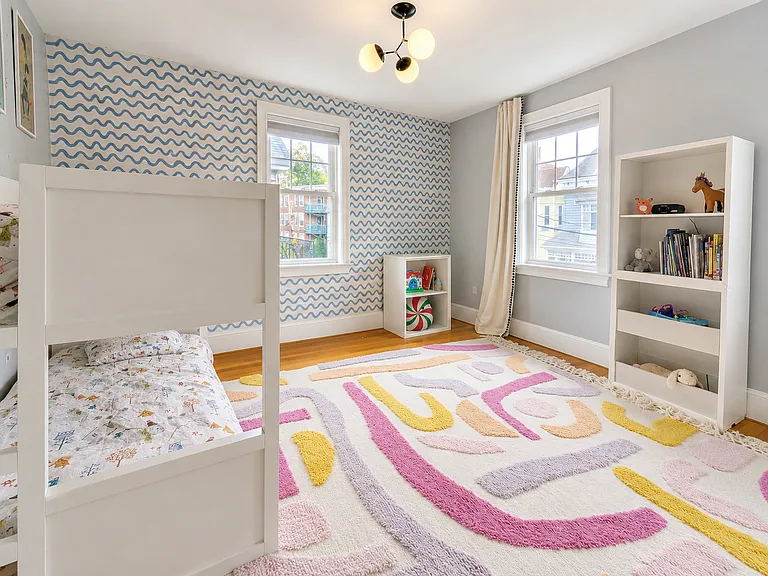 Bright bedroom or office with a stylish patterned accent wall_adds character while maintaining a clean, versatile feel