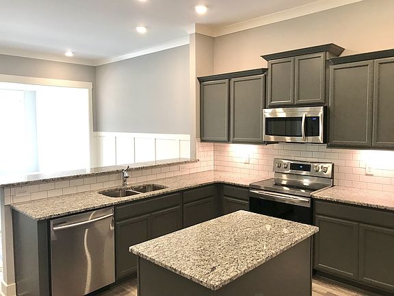 Stock photo of working island looking into dining area with wainscoting