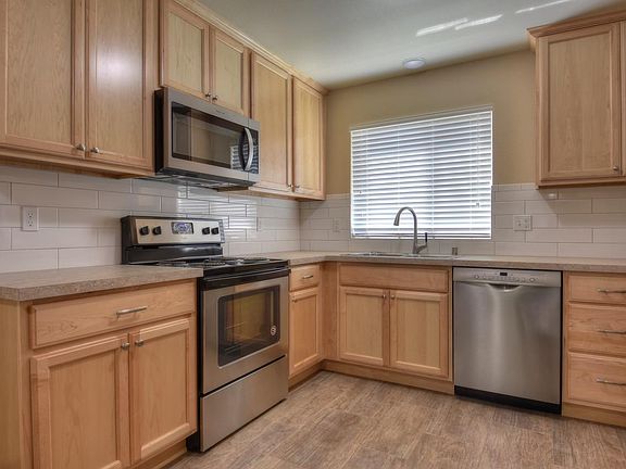 A thoughtfully planned kitchen you_ll love to cook in. Stainless steel appliances and full height tile backsplash.