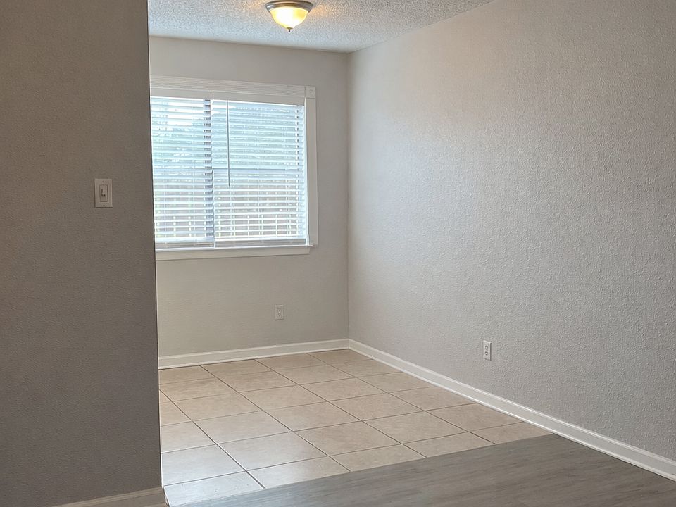 Open living and dining space featuring updated flooring and plenty of natural light