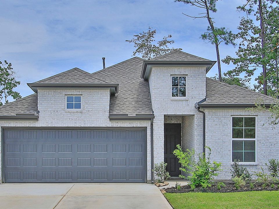 Timeless brick facade and sleek gabled roof exude sophistication in The Woodlands Hills serene sett