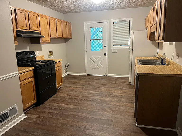 Large kitchen with laundry hookups. Back door to covered porch and utility room.