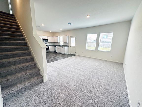Living room area with stairs on left.