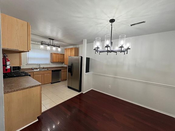 Upgraded kitchen with new Stainless steel appliances - stove and dishwasher. The dining area is next to it. New chandeliers with LED lights installed.