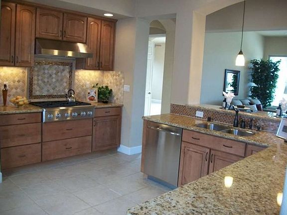 "Attractive and functional gourmet kitchen with granite countertops..."