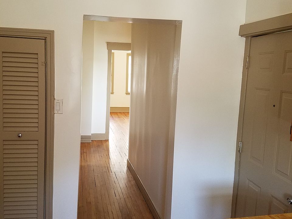 Kitchen leading to living room. Back door on right