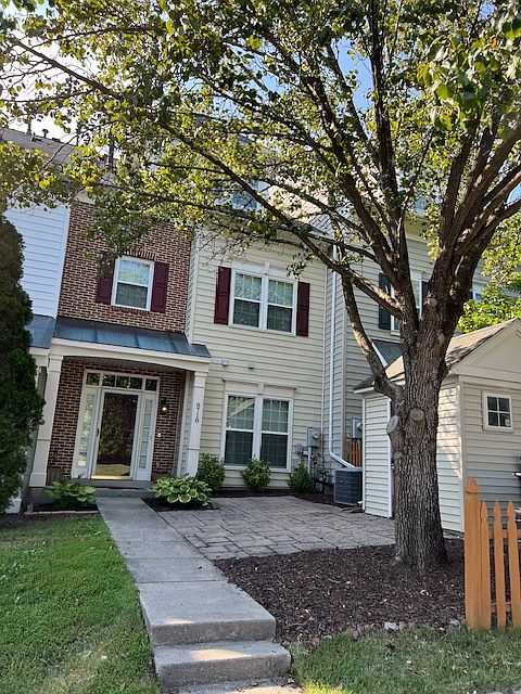 Front entrance of home with 1/2 shed on property.