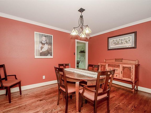 Warm and welcoming, the formal dining area feature real hardwood flooring, tiffany style chandelier, crown and door moldings . . .