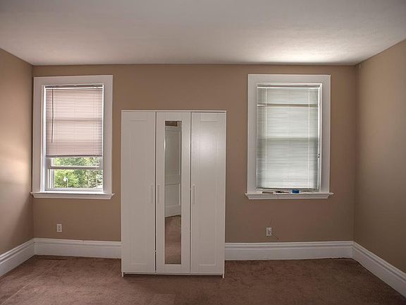 Second bedroom overlooks backyard. Armoire for extra storage