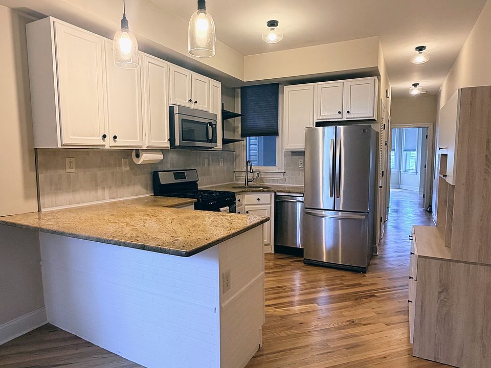 Kitchen - Bar stool seating area, dishwasher, oven & gas stovetop, fridge & microwave. Extra Pantry & appliance storage unit.