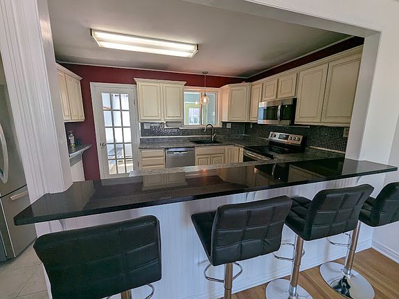 Open kitchen with bar seating.