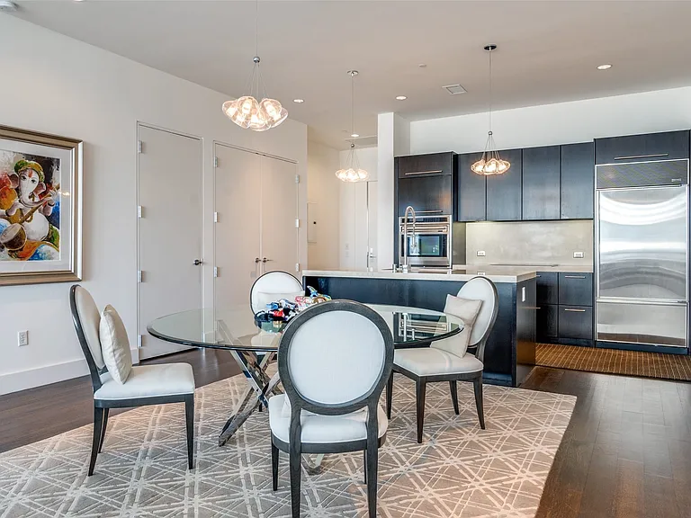 Dining room with recessed lighting, dark wood-type flooring, and a chandelier