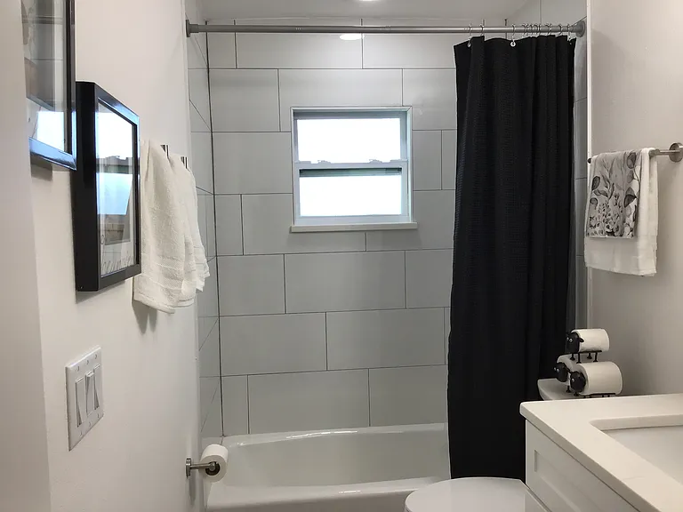 Bright and functional main bathroom designed for everyday comfort is located off the center hallway.