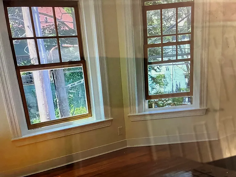 The large living room has expansive long multiple windows that creates an incredible cross-breeze and abundant natural light.