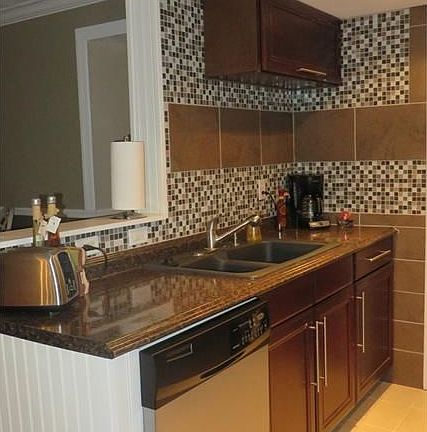 Updated Kitchen cabinets & counters, stainless appliances & tile backsplash.