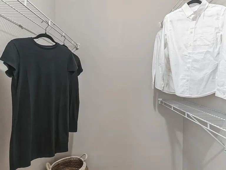 Spacious walk-in closets feature built-in organizers for organized luxury.