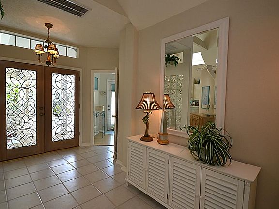 Foyer entryway is true elegance with double leaded glass doors. Stunning!