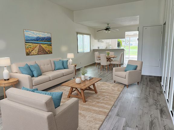 View from the front door. Fresh interior paint throughout and new laminate floors. NOTE: Photo has been virtually staged.