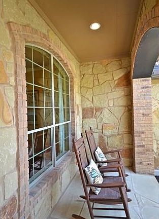 Enjoy the sights and sounds of the neighborhood from the covered front porch.