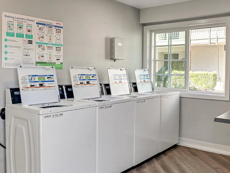 A row of washing machines in a laundromat.