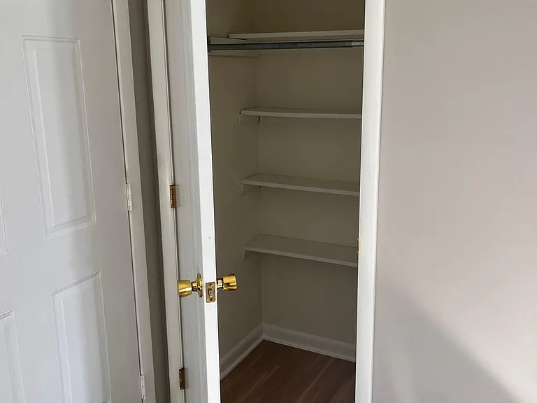 coat closet with shelving in the living room