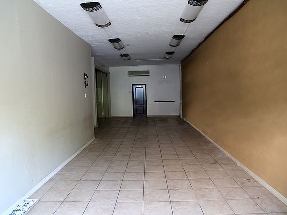 Commerical area with backdoor leading to office