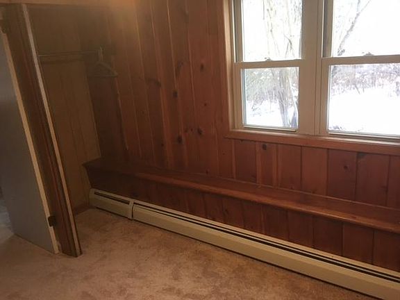 Bedroom, looking out western windows (wood paneling)
