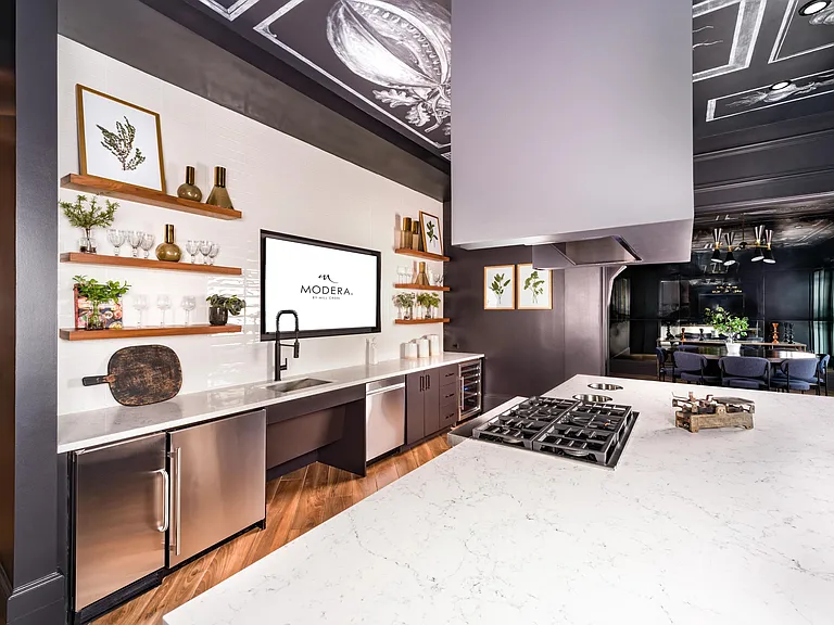The demonstration kitchen at Modera Old Ivy pairs chef-inspired finishes with open gathering space, designed for hosting in the heart of Atlanta.