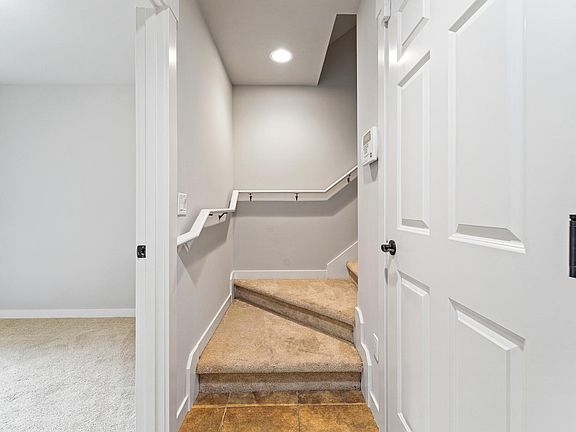Stairs leading to the main floor
Left door side: Room with a 3/4 bath and access to the pocket patio
Right door side: Garage and storage