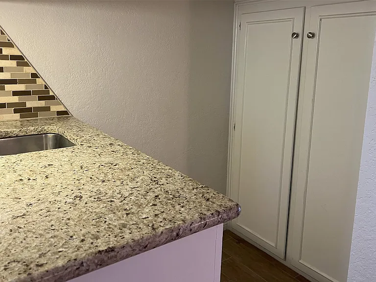 The wet bar also has storage under the stairs