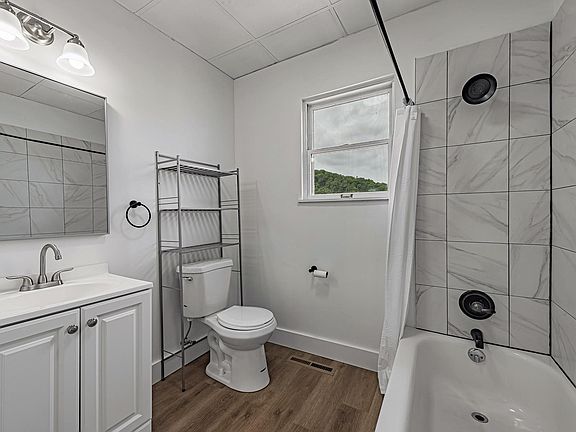 Fully renovated full bathroom with tile shower and rub