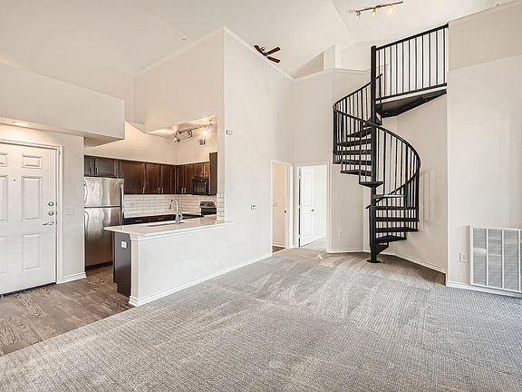 A Kitchen with a Spiral Staircase at Fox Run Lofts
