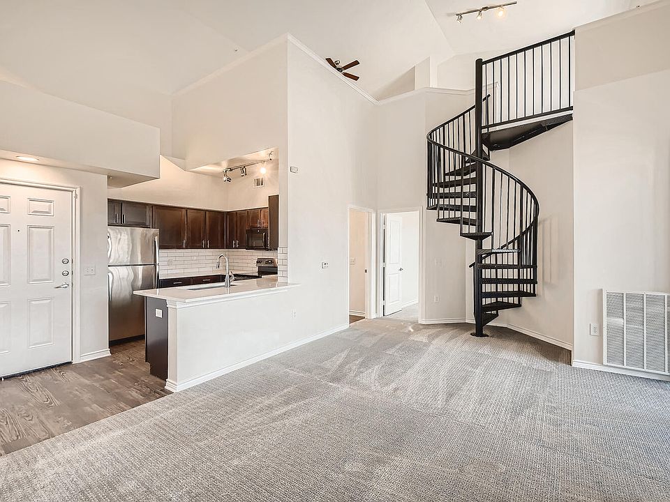 A Kitchen with a Spiral Staircase at Fox Run Lofts