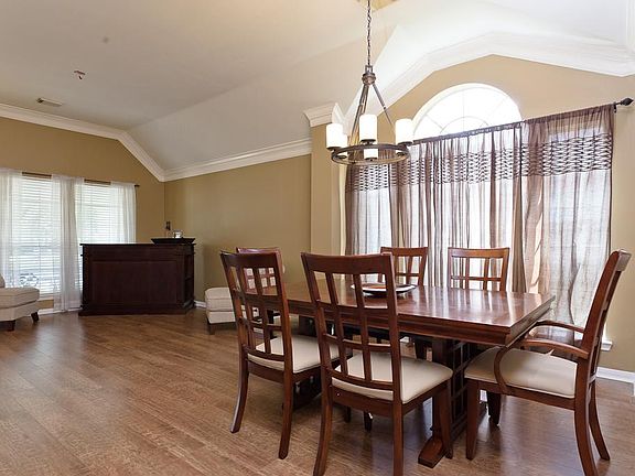 Formal dining room flows seamlessly from the formal living and offers laminate wood floors and chandelier.