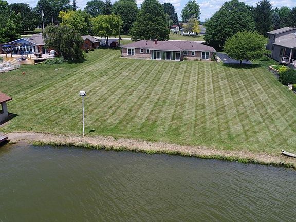 Large yard right on the water including beach and deck.