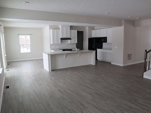 Family room & kitchen with luxury flooring, cabinets and all appliances