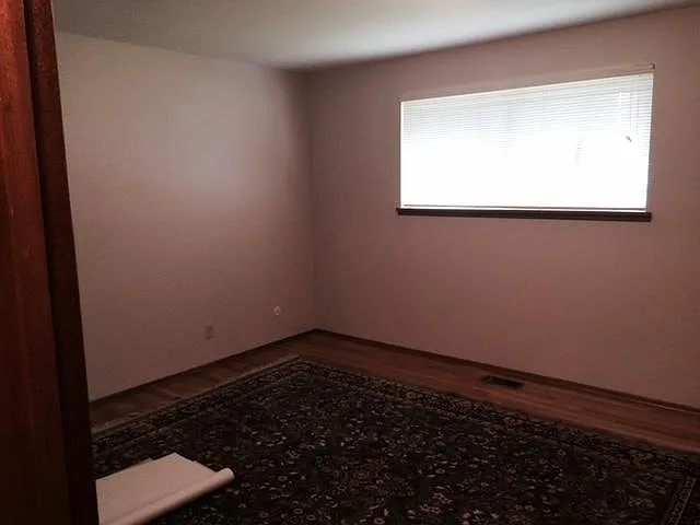 Front bedroom with large closet and hardwood floors