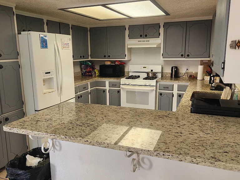 Kitchen with new dishwasher and granite countertops