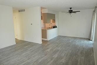 Living room facing dining area, kitchen and hallway