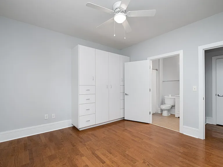 2nd bedroom with large armoire wardrobe. You can see the private bathroom as well