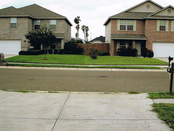 Homes in front of this hom in this manicured gardens community.