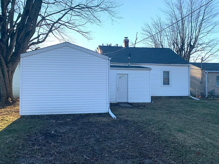 The backyard is spacious, and there's an alley that runs along the back of the property.