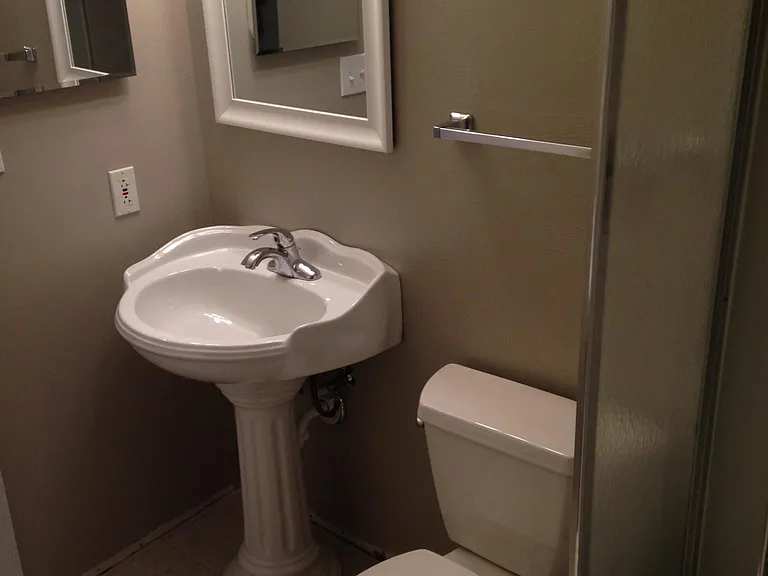 Lower-level bathroom with shower enclosure.