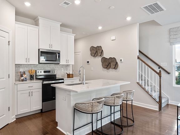 The well-appointed kitchen with a large island makes meal prep a breeze.