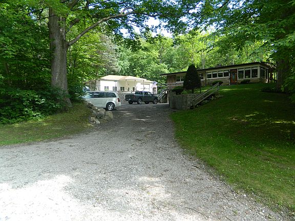 Driveway. House to right shop pull barn to left