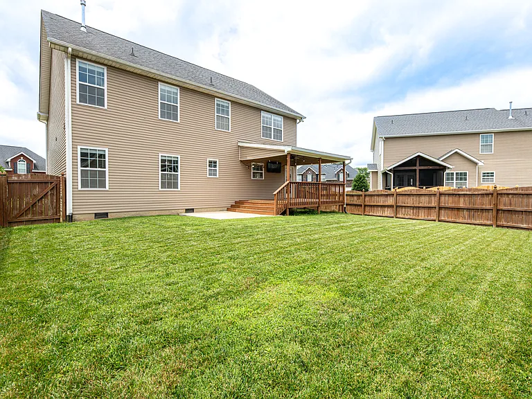 Relax in a fully fenced-in backyard designed for entertaining. The upper deck steps down to a dedicated concrete pad perfect for grilling. Unwind in the evening under the cozy string lighting or watch the game on the outdoor tv