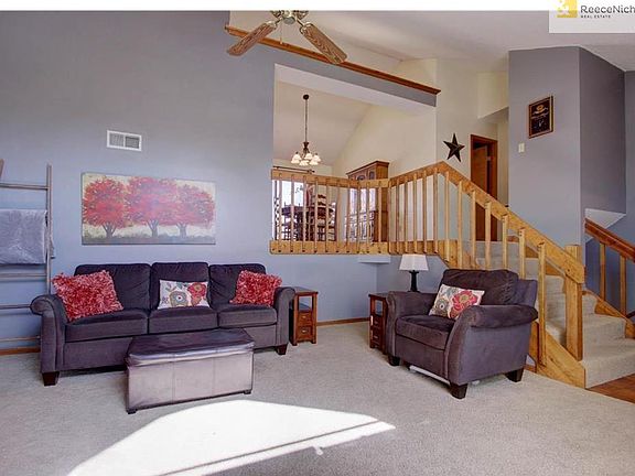 Great room with vaulted ceilings, opens to breakfast room and kitchen.