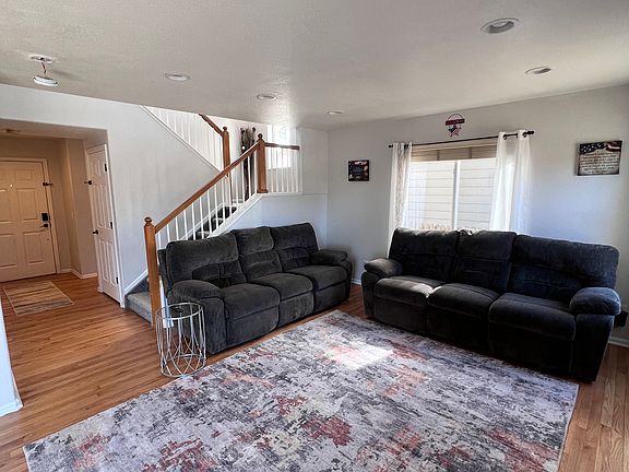 Fully furnished throughout. Pictured is the living room and front door.